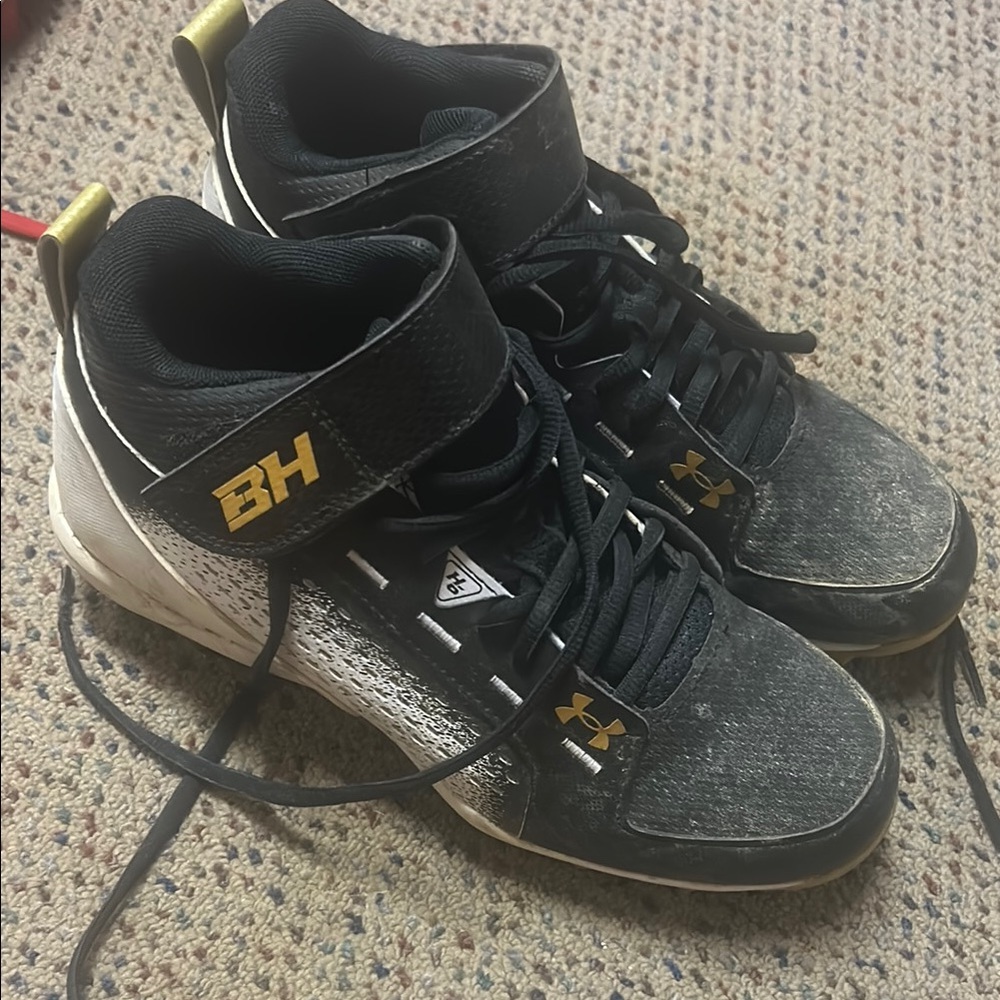 Under Armour Black and Gold Cleats with Lace-Up Design